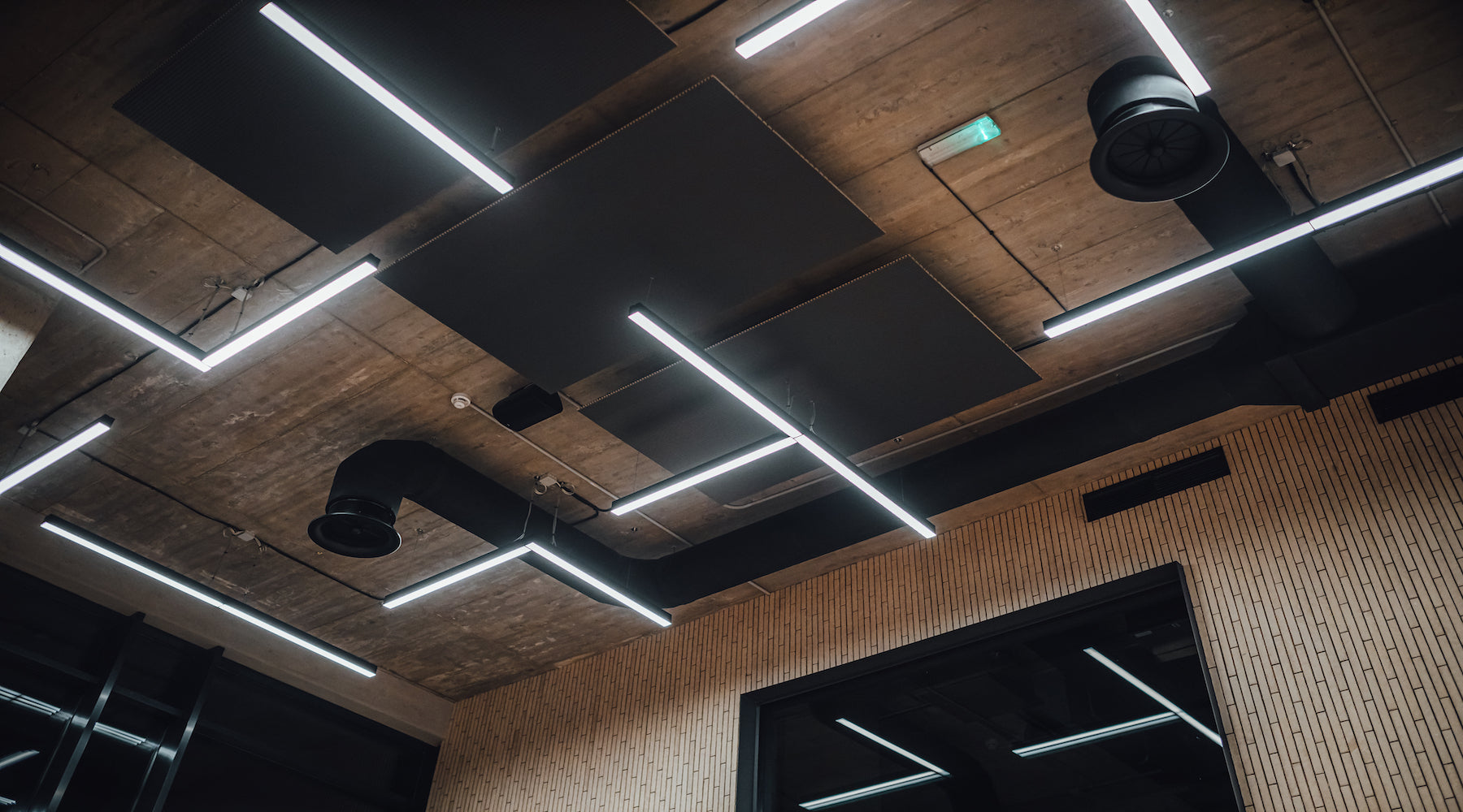 LED lights suspended from ceiling in a commercial building space