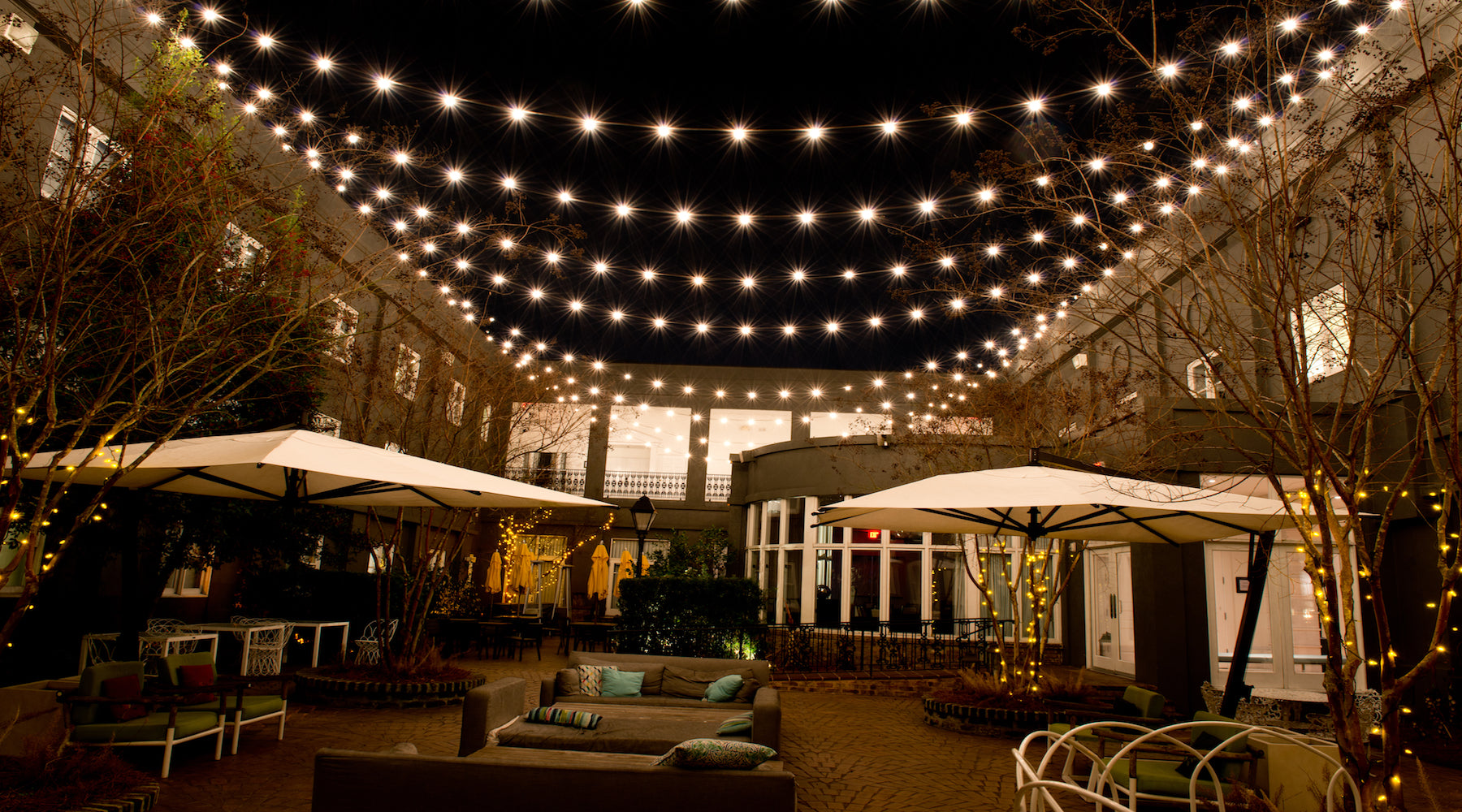 Outdoor string lights hanging over outdoor courtyard