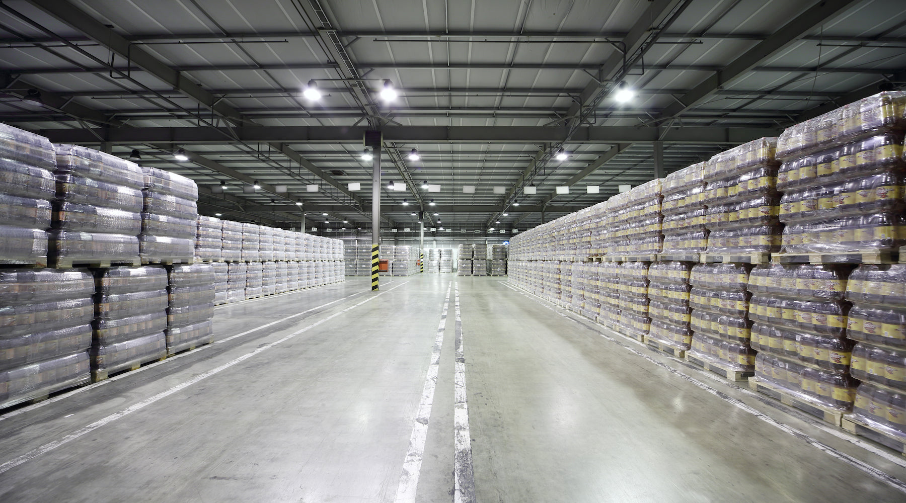Warehouse lighting installed in large warehouse area storing pallets of beer