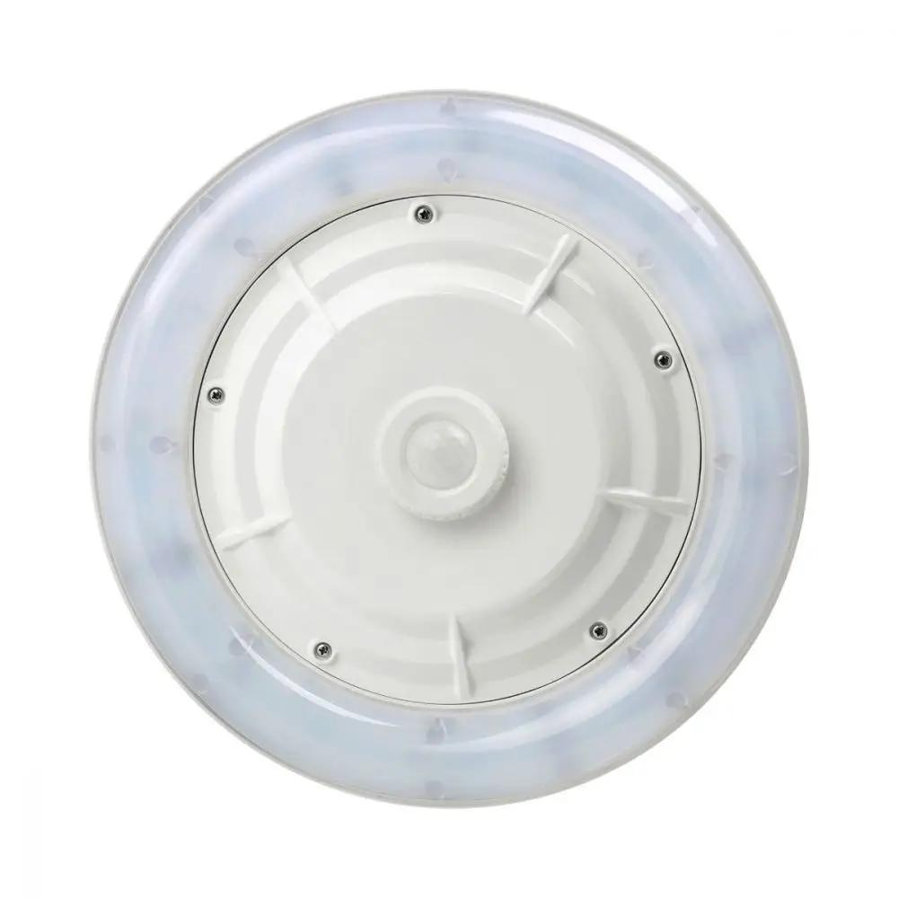 LED Parking Garage Canopy Lighting Fixture: A circular white object with a round base and a round knob. It has a white circle with a bubble in it and screws.