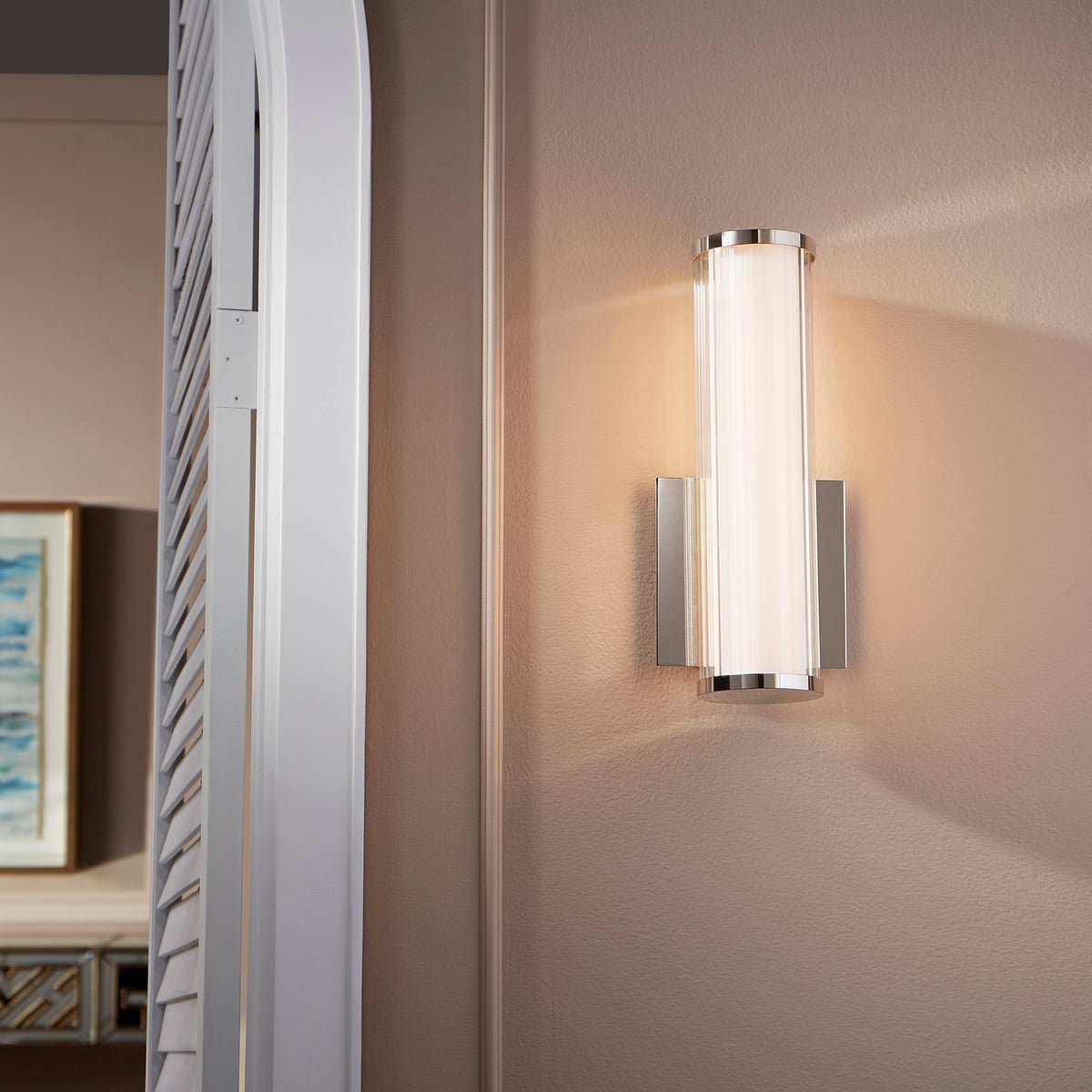 LED Wall Sconce with clean lines and subtle sophistication, perfect for modern applications. 9W, 120V, 689 lumens, 3000K color temperature, dimmable. UL Listed, Damp Location safety rating. Noir, Oiled Bronze, Polished Nickel, Satin Nickel finishes. 5.13"W x 12.5"H x 4"E. 2-year warranty.