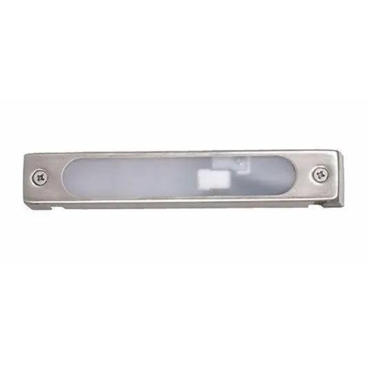 Landscape Deck Light, a close-up of a white rectangular object with a square in the middle, designed by Sollos Lighting for safe outdoor illumination. Crafted from durable die-cast aluminum with a frosted glass lens, it seamlessly blends into any outdoor area. 6"W x 1"H.