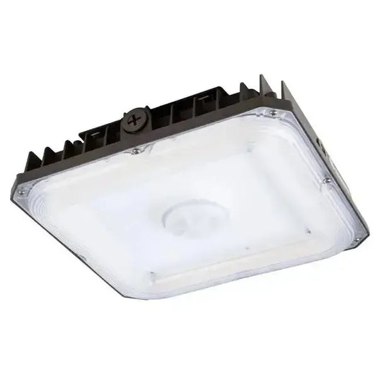 Angled underside view of CanoLux Series LED canopy light showing optical lens and integrated sensor receptacle for commercial canopy lighting controls