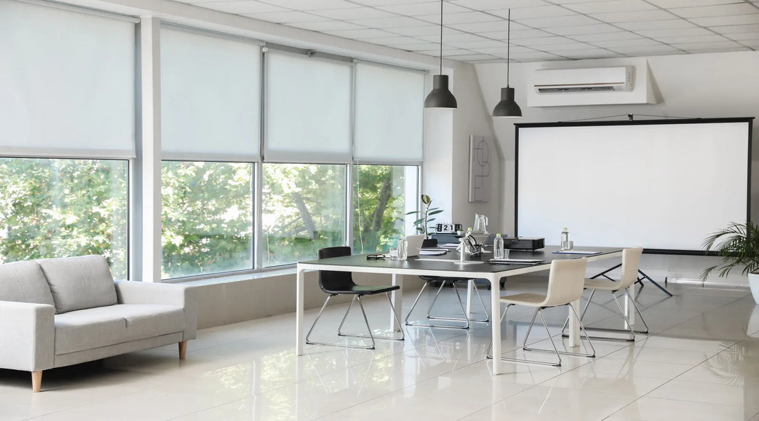 Pendant lighting shown over table in conference hall of modern office