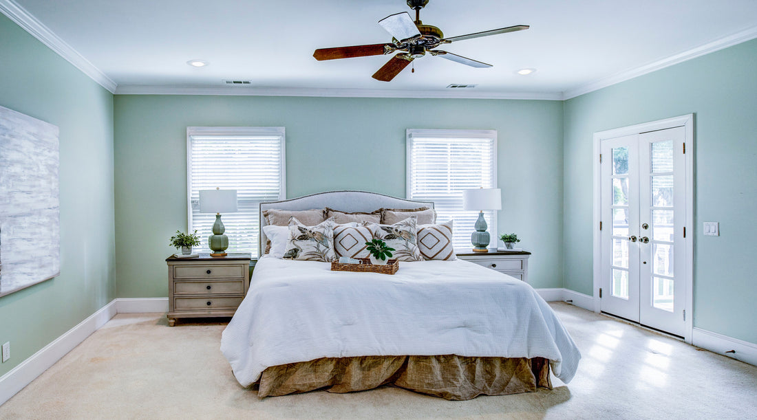 Ceiling fan shown in beautiful master bedroom with windows and glass doors