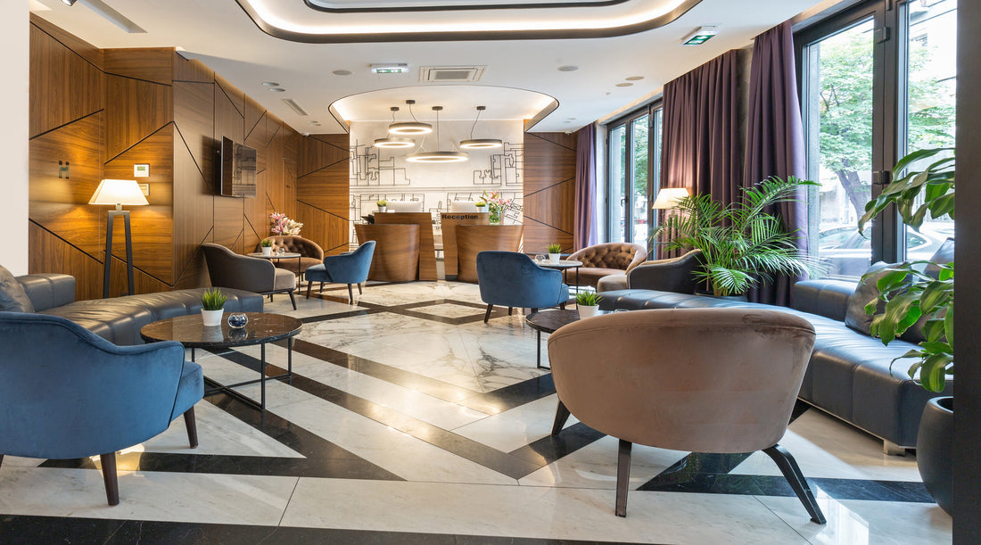 Chandelier and recessed lighting shown in modern luxury hotel reception area