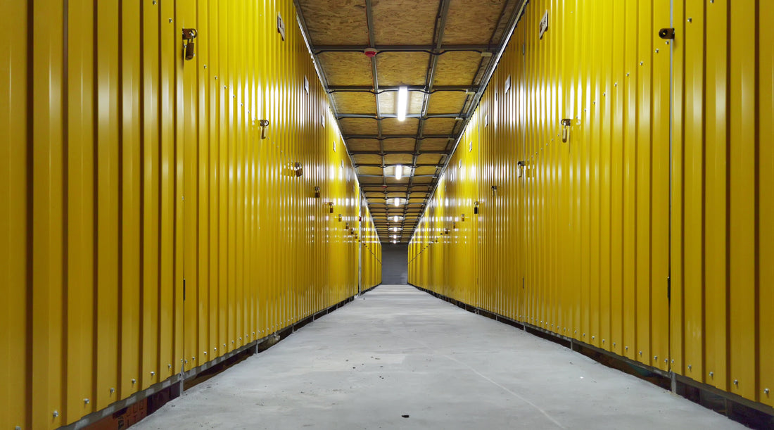 Drop ceiling lighting fixtures used in hallway with yellow storage units