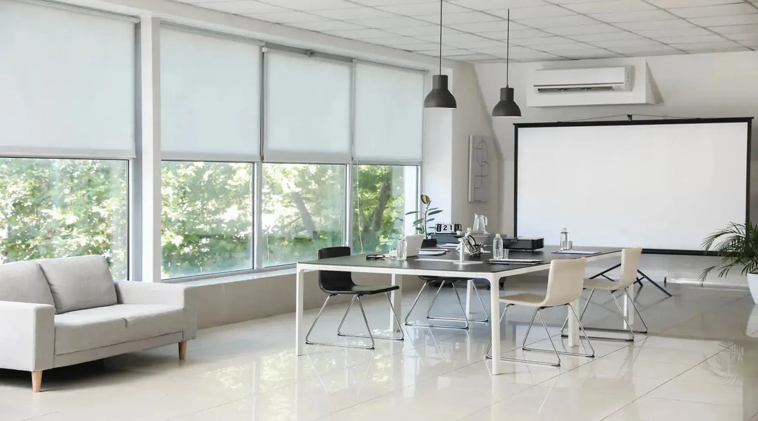 Pendant lighting shown over table in conference hall of modern office