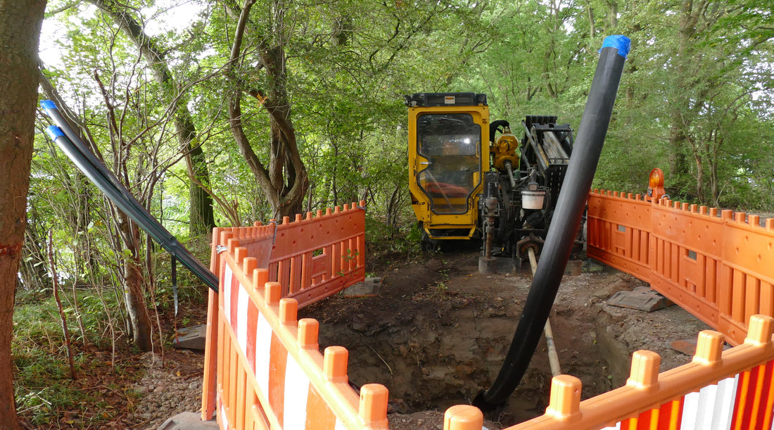 Heavy equipment being used to dig trench for buried outdoor electrical wire