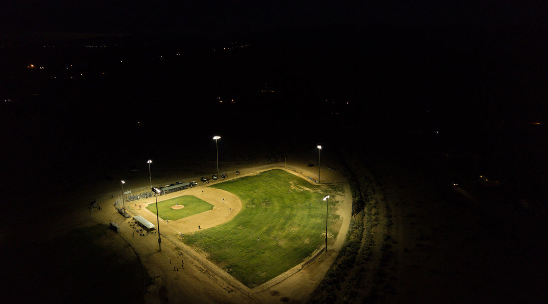 High powered flood lighting illuminating baseball field at night