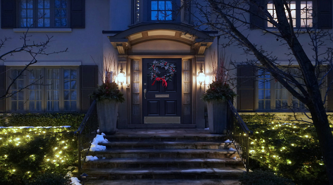 House with LED outdoor lights on each side of front door along with Christmas lights and decorative wreath
