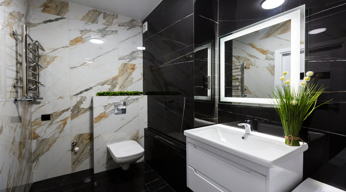 LED mirror shown in modern small bathroom with white and black marble tiles