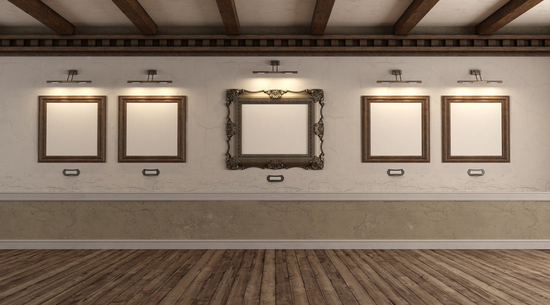 Lights illuminating empty picture frames in gallery