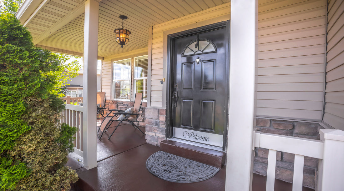 Outdoor hanging light shown on porch with chairs and brown door