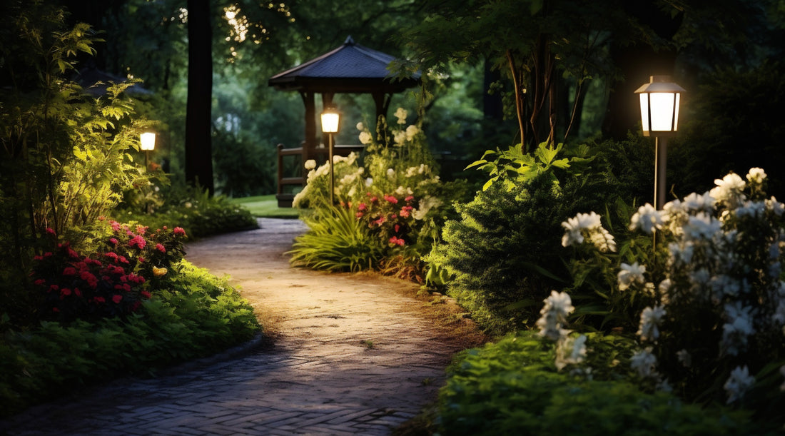 Outdoor post lights illuminating lush garden with flowers and plants