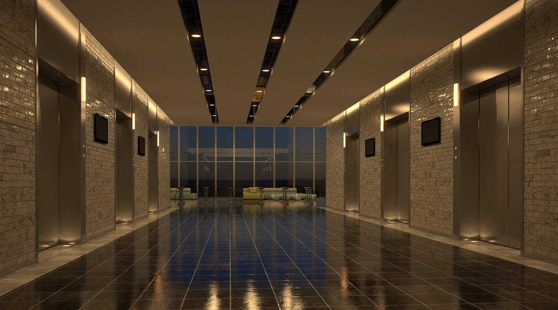 Recessed can lighting installed in modern commercial setting near elevators
