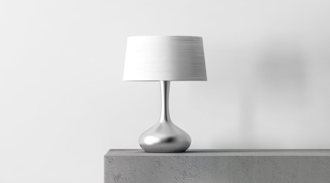 Stylish table lamp with white shade shown in white room