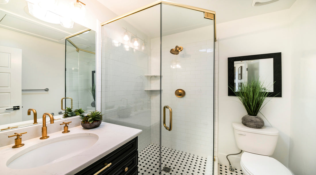 Vanity light shown in stylish luxurious bathroom with black and gold fixtures