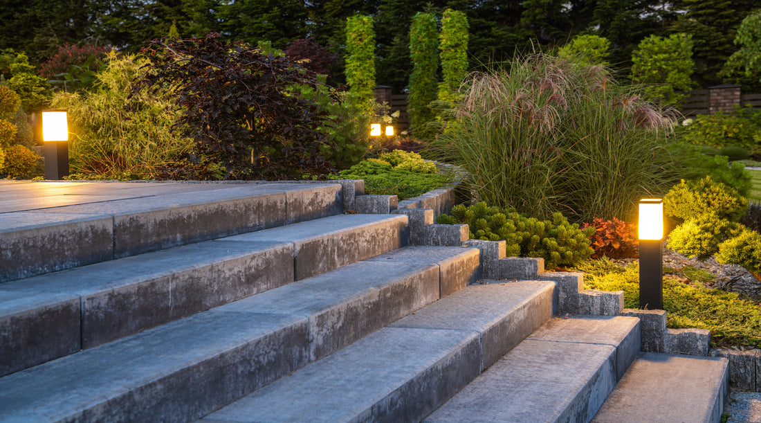 Yard lights shown illuminating landscaped garden with concrete stairs