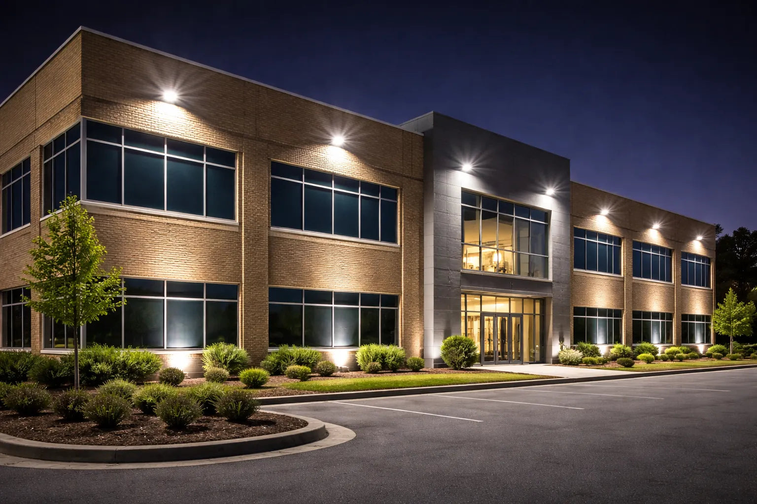 LED flood lights shining upward to illuminate a commercial building facade at night