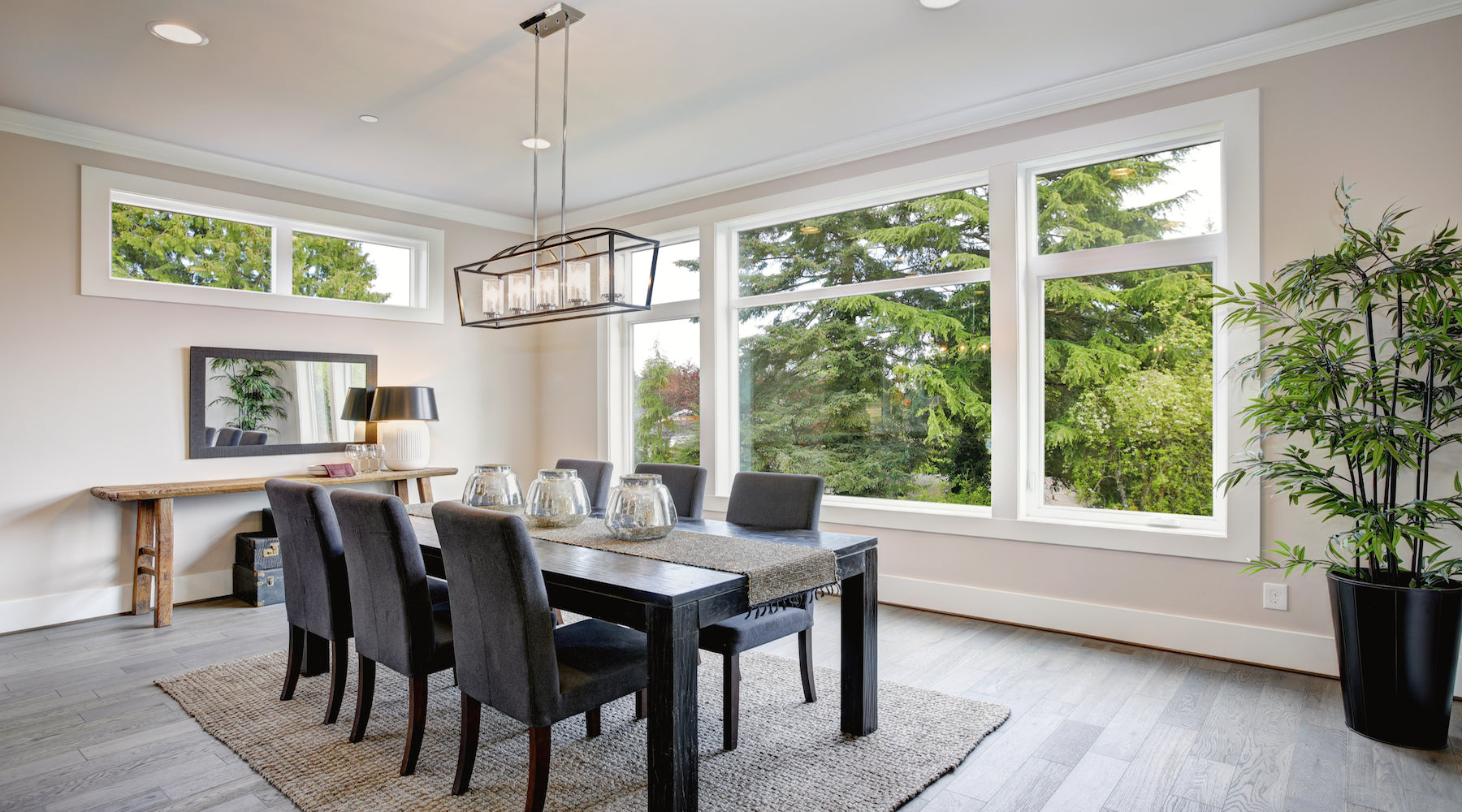 Chandelier hanging over table in modern luxurious dining room