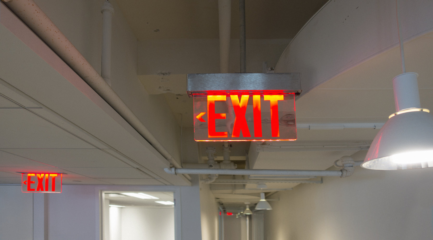 Exit emergency lighting installed in a hallway