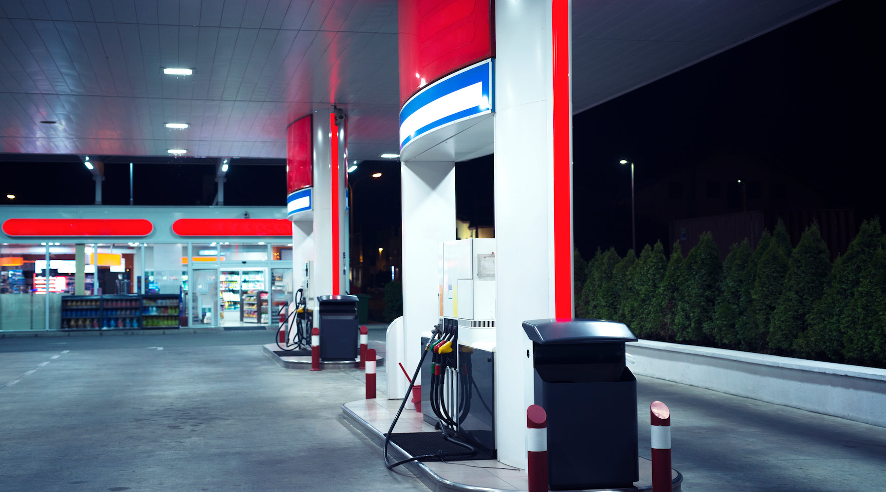 Gas station lighting illuminating fuel dispensers at night