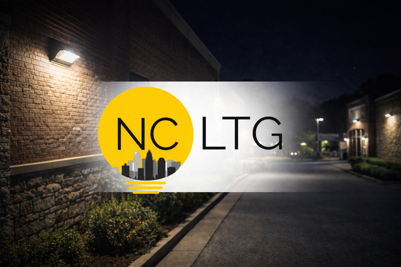 NCLTG LED wall pack and outdoor area lighting illuminating a commercial building exterior at night