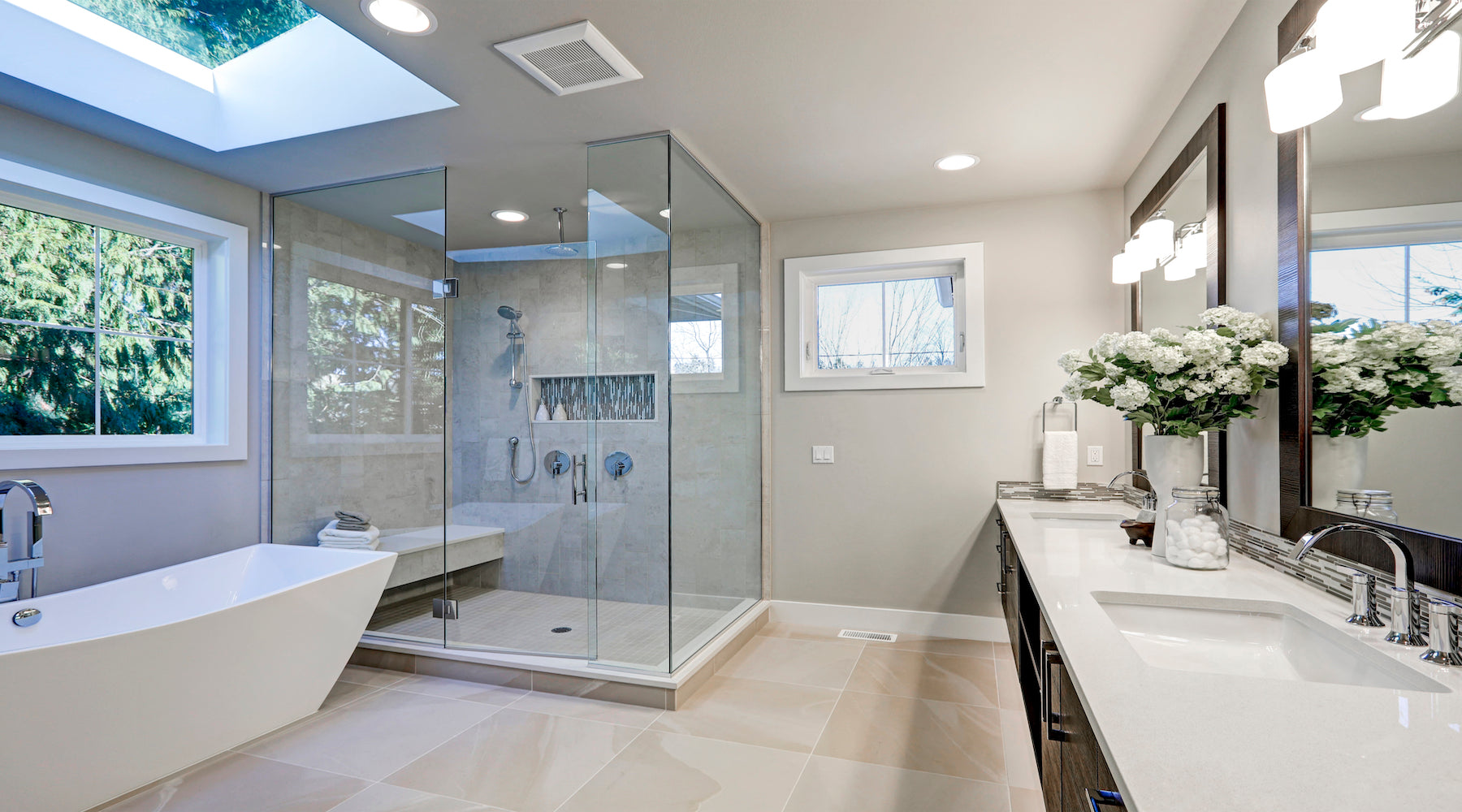 Shower lighting installed in spacious bathroom with grey tones and heated floors