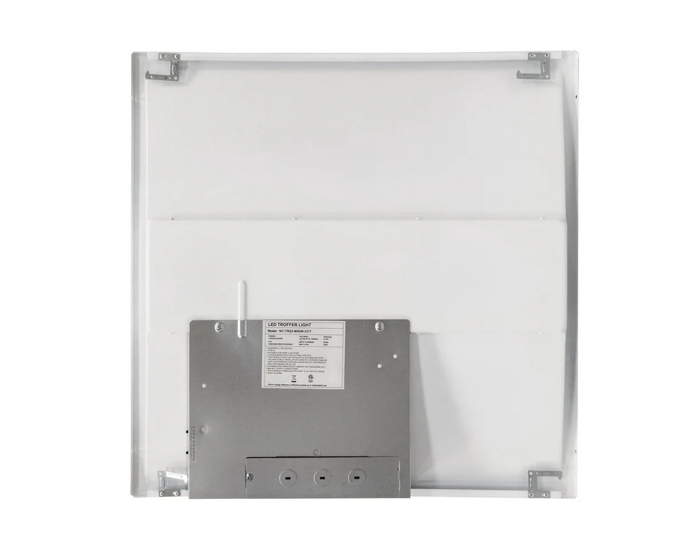 Back view of the 2×2 LED drop-ceiling troffer showing the wiring compartment with conduit knockout points, plus side-access CCT-select and wattage-select slide/DIP switches on the electrical box; 120–277V input, wattage-select 15/20/25/30/40W delivering 1,950–5,000 lumens with 3500K/4000K/5000K/5700K/6500K CCT options.