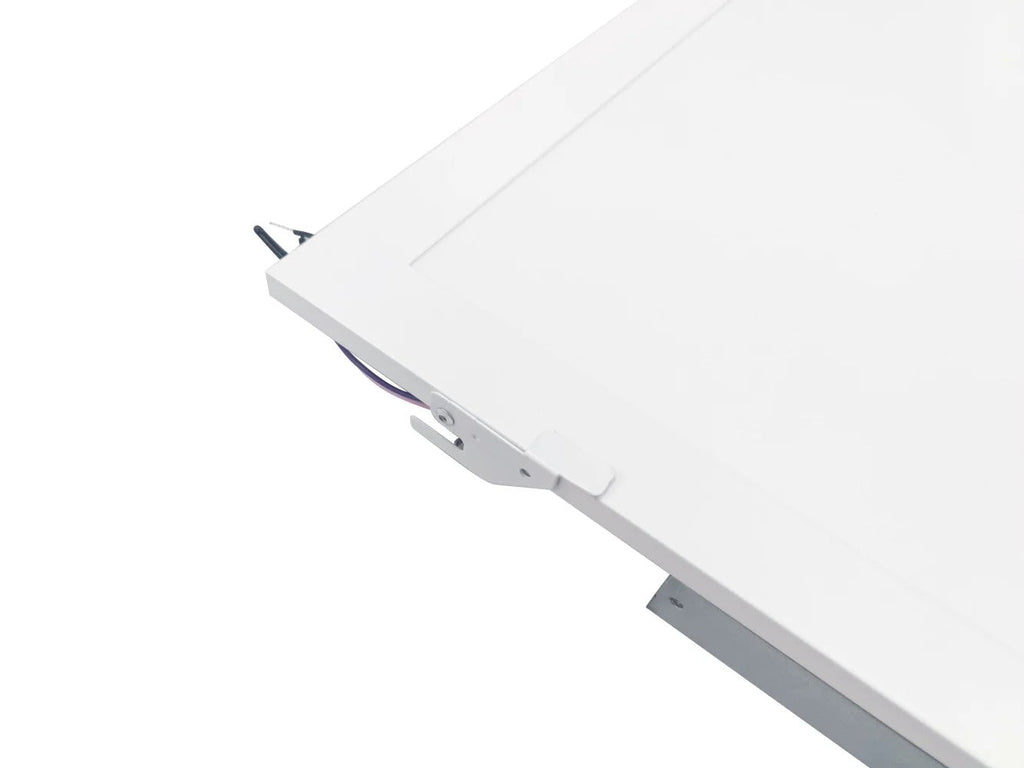 Tight angled view of the 2x2 LED panel retrofit showing the lens and ceiling-grid clip interface for T-bar installation; 0–10V dimming, 1950–5000 lm, CCT selectable 3500K–6500K, 120–277V.