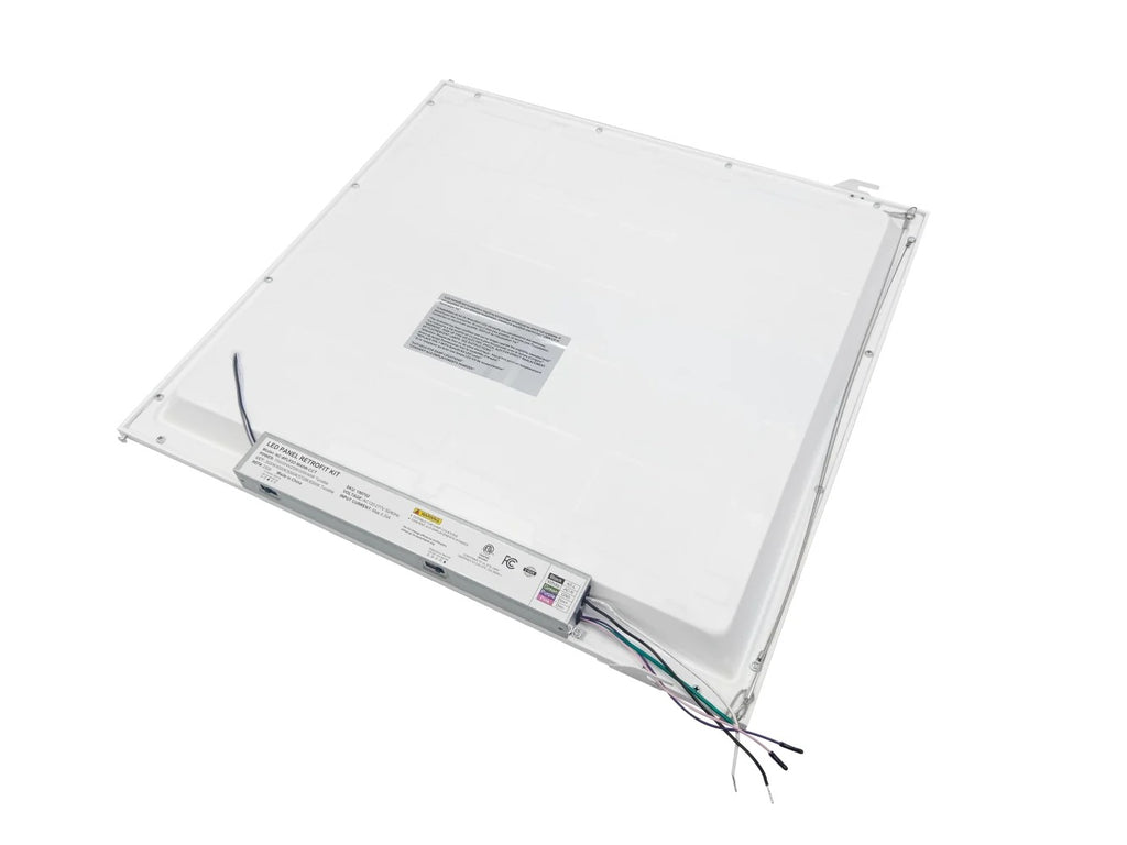 Back view of the 2×2 LED panel retrofit showing the safety cable, grid clips, and driver with CCT- and wattage-selectable dip/slide switches; black, white, green, and pink leads exit the end of the driver for field wiring, 15/20/25/30/40W, 1,950–5,000 lm, 3500K/4000K/5000K/5700K/6500K, 0–10V dimming, 120–277V.