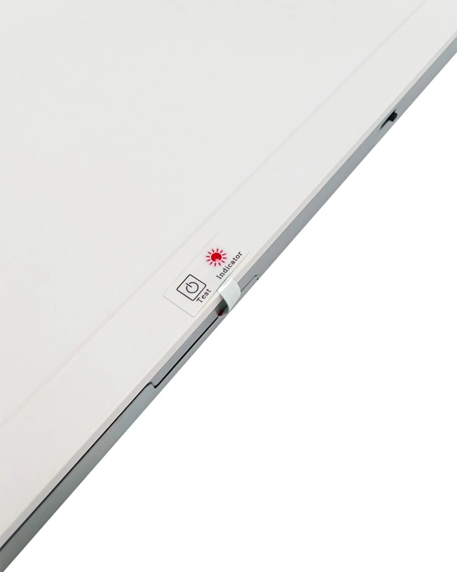 Macro close-up showing the emergency test/indicator switch assembly on the 2x2 LED drop-ceiling light with integrated sensor receptacle + emergency backup; wattage selectable 15/20/25/30/40W, 1950–5000 lm, CCT selectable 3500K–6500K, 120–277V.