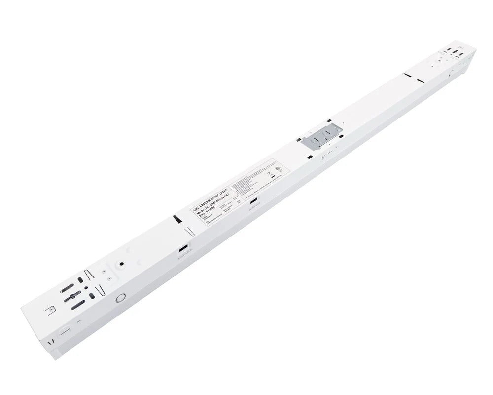 4ft LED strip light rear housing view showing the wiring compartment with knockout locations and integrated driver area, plus side-access CCT-select and wattage-select switches; 120–277V input with 0–10V dimming, 25/30/35/40/50W selectable delivering 3,750–6,500 lumens with 3500K/4000K/5000K/5700K/6500K options.