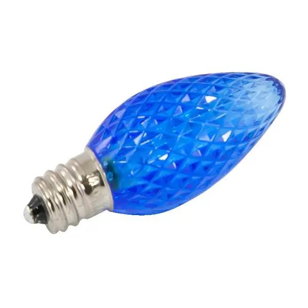 A close-up of the C7 LED Replacement Bulb, a blue light bulb with a silver base. Provides bright and long-lasting light output, perfect for holiday lights. Ideal for rooftops, fences, and driveways. 0.8 Watts, 120V, 525 Lumens, dimmable, candelabra E12 base. Made with faceted plastic lens. UL Listed, CSA Listed. Dimensions: 0.8125"D x 2.15625"H. Rated Hours: 15,000.