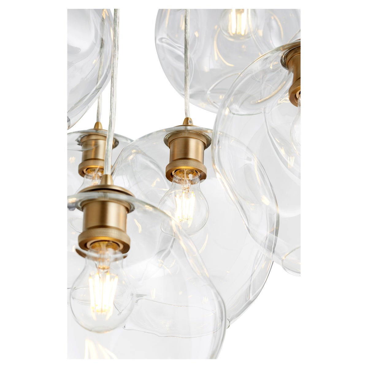Cluster Pendant Light with clear wavy glass globe shade and adjustable cord suspended from a matching canopy. Crafted of metal in a stylish finish. Brighten your space in contemporary style.
