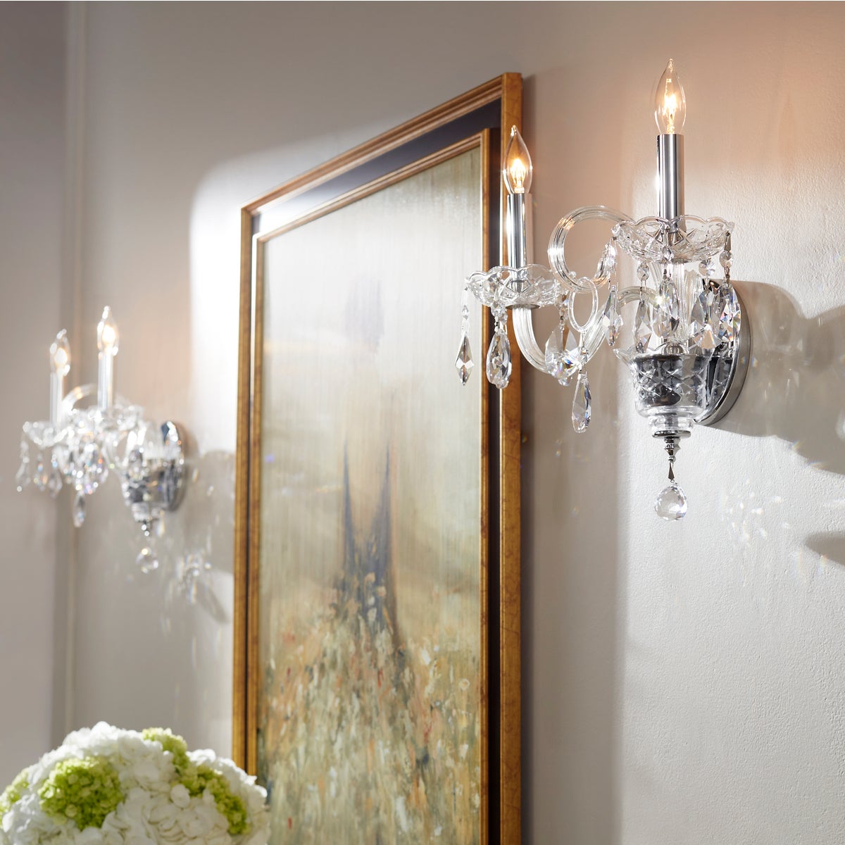 Crystal Wall Sconce with tear drop crystal accents, bringing classic design from 1740 into the present era. Chrome fixture with prismatic effects, adding a luxurious touch to any space. 2-bulb, 60W, dimmable, UL Listed. Dimensions: 13.5"W x 10.5"H x 8.5"E. Warranty: 2 Years.
