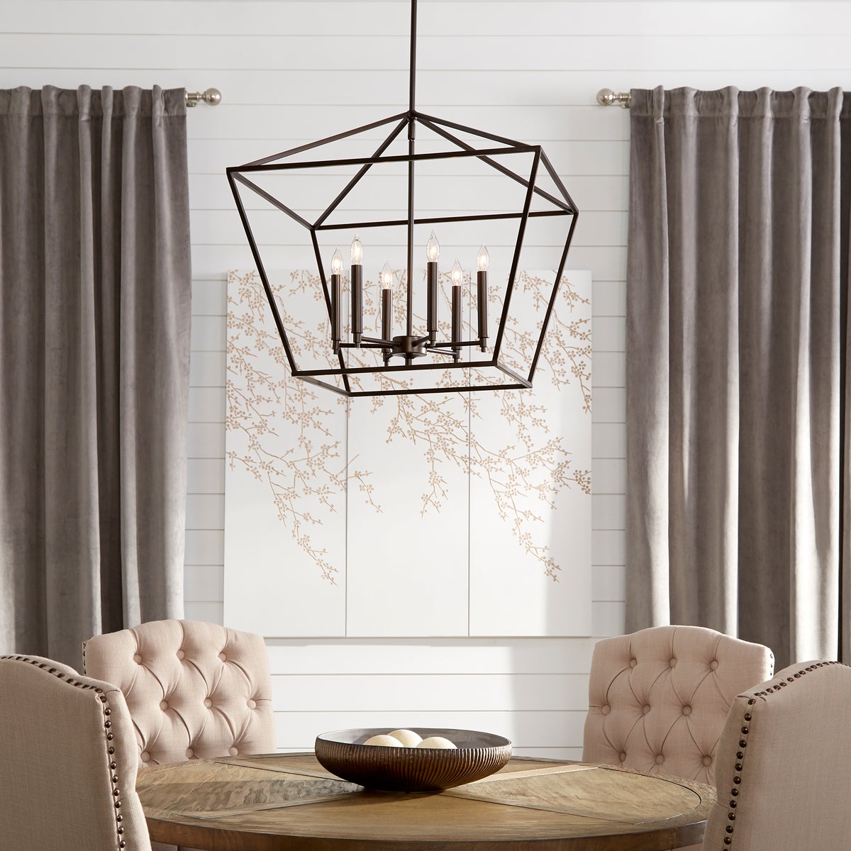 A farmhouse pendant light hangs above a table, providing ample illumination. Perfect for adding farmhouse charm to your space.