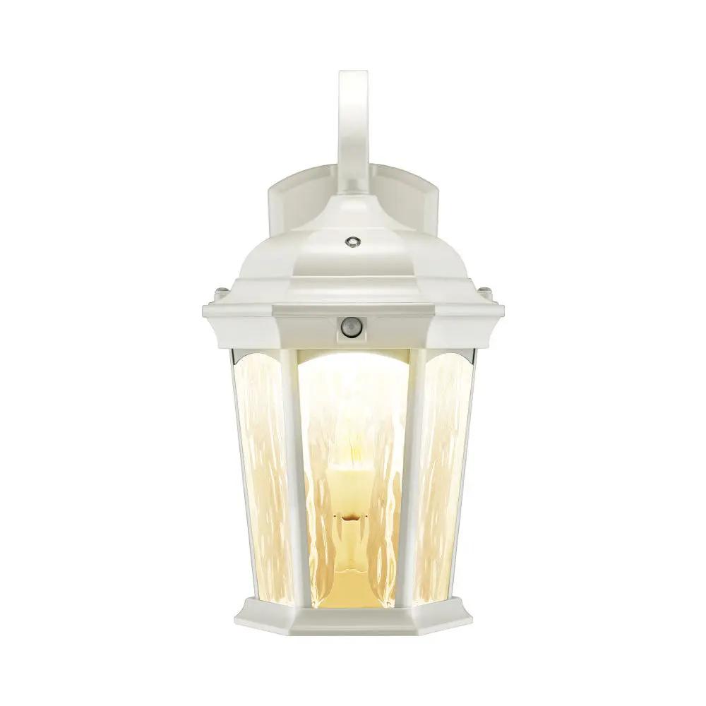 A white flickering flame lantern with water glass and swooping S-hook arm, designed with dusk to dawn technology and motion sensor detection.