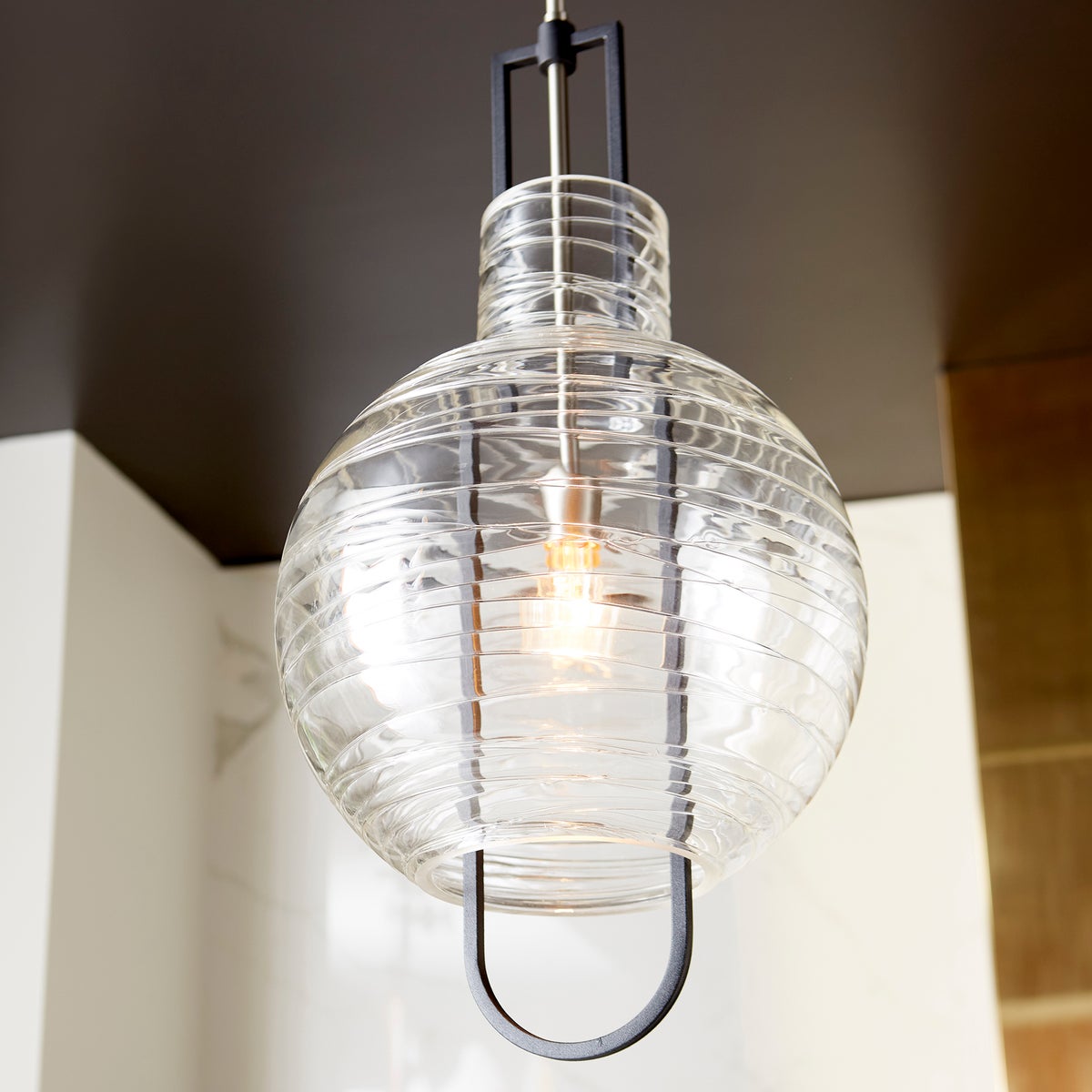 Globe pendant light fixture with blown clear textured glass shade and noir/satin nickel finishes. Dual chain and stem hanging system for adjustable height. Enhance your space with this contemporary-chic lighting.