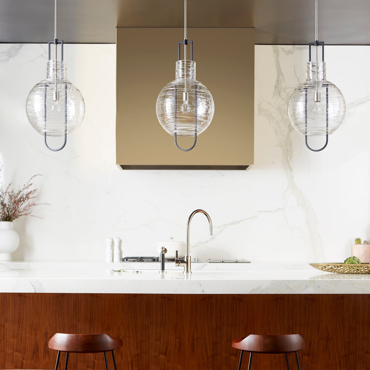 Globe Pendant Light with blown clear textured glass shade and two-toned noir/satin nickel finishes. Dual chain and stem hanging system for adjustable height. Enhance your kitchen, bedroom, or bathroom with this contemporary-chic lighting fixture.