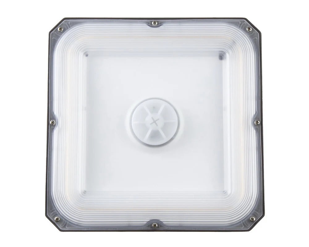 Bottom lens view of the LED canopy luminaire showing the centered sensor port cap and sealed lens perimeter; 20/30/40W, 3,158–5,835 lm, 3000K/4000K/5000K, IP65, 0–10V dimming, 120–277V.