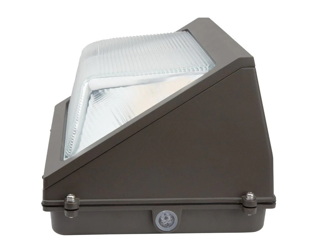 Side view of the bronze LED wall pack showing the lens and the edge-mounted knockout point for wiring entry; 30/40/50/60W, 4,770–9,471 lm, 3000K/4000K/5000K, IP65, 0–10V dimming, 120–277V.