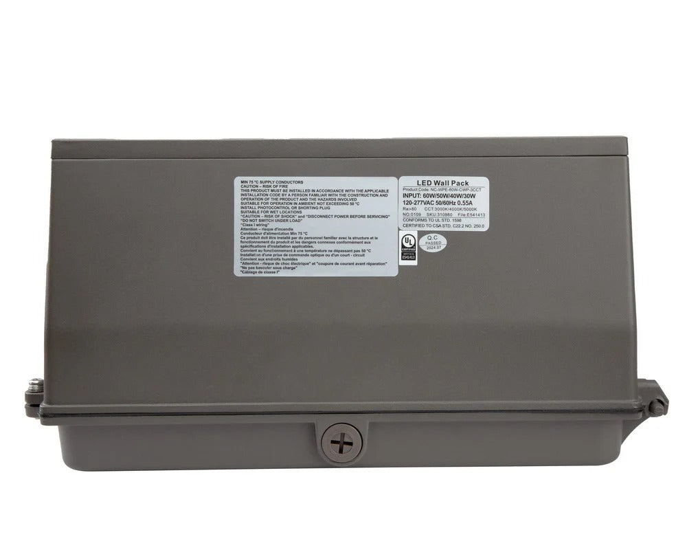 Top view showing the compact bronze wall pack body and backplate with the conduit knockout point visible for electrical entry; 30/40/50/60W, 4,770–9,471 lm, 3000K/4000K/5000K, IP65, 0–10V dimming, 120–277V.