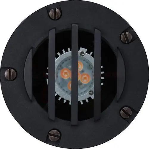 Landscape Well Light: A round black object with metal bars, perfect for adding up-light to trees, walls, and garden art. Adjustable socket for precise lighting. 50W, 12V, MR16 bulb not included. Dimmable. ETL Listed. Wet Location. Antique Brass and Composite Black finish. 4.9"W x 4.75"H. 10-year warranty.