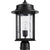 A black mid century modern outdoor post light with clear glass panels, perfect for illuminating your home's exterior. Made from durable metal, this fixture features a clean-lined drum silhouette and hammered glass panes for added embellishment. Fits a single dimmable 100W bulb (not included).