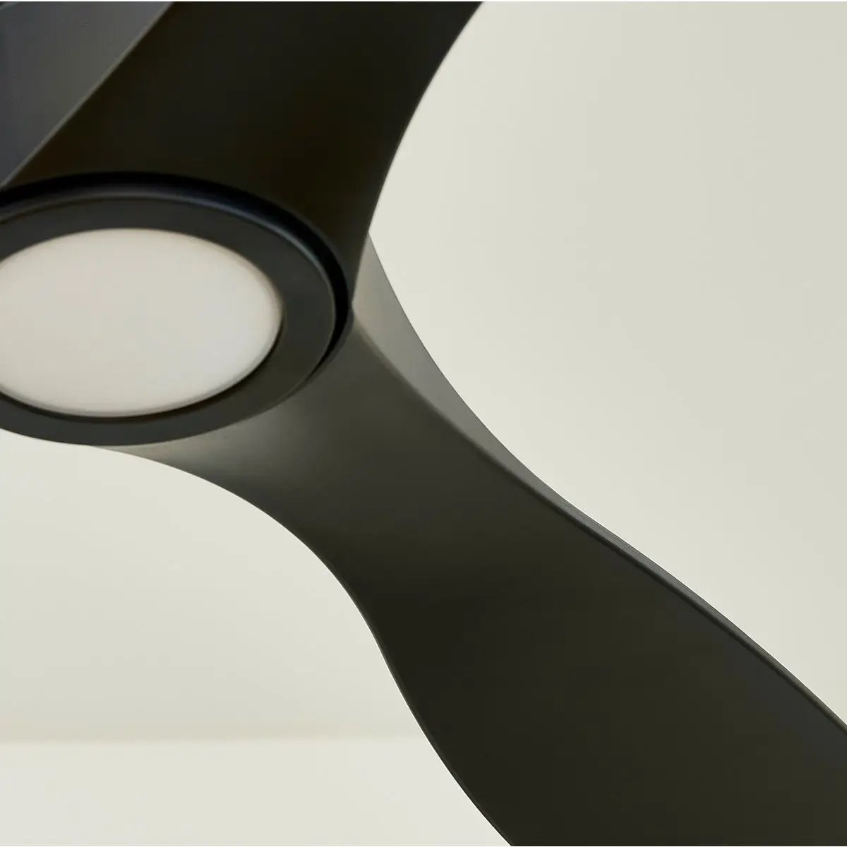 A close-up of a modern ceiling fan with light, featuring a sleek design and monochromatic blades. Provides powerful and long-lasting air circulation.
