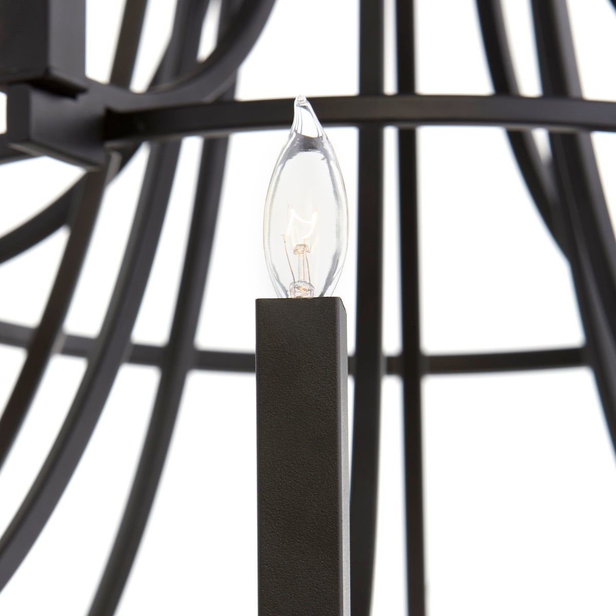 Black Chandelier with geometric design and interchangeable candle sleeves. Suspended from adjustable chain and stem mounting system. Perfect for any interior space.