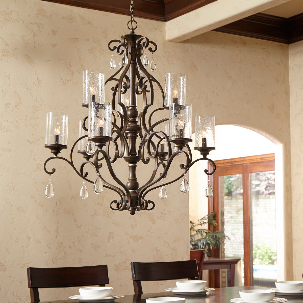 A Spanish chandelier with curved arms and clear crystal accents, adding a touch of sophistication to your space. Brand: Quorum International. Wattage: 60W. Input Voltage: 120V. Number of Bulbs: 9. Bulbs Included: No. Bulb Base Type: Candelabra E12. Dimmable: Yes. Certifications: UL Listed. Safety Rating: Dry Location. Finish: Persian White, Vintage Copper. Dimensions: 32"W x 37"H. Warranty: 2 Years.