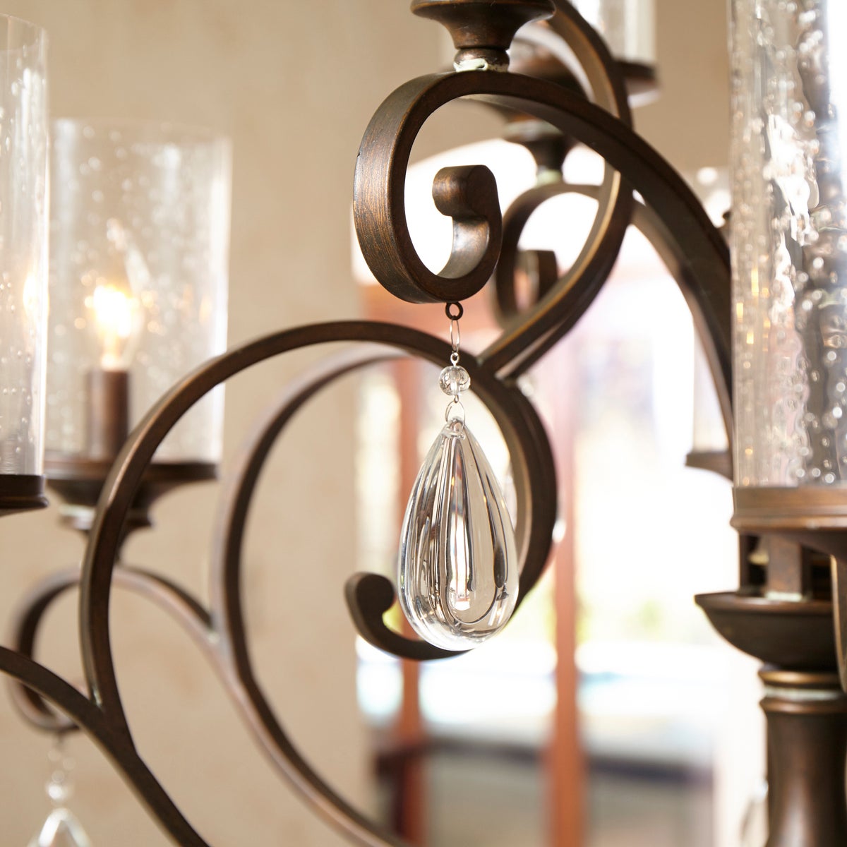 A Spanish chandelier with curved arms and clear crystal accents, blending traditional elegance with an updated appeal. Perfect for adding a touch of class to your space.